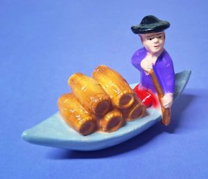 6 - Homem transportando pipas no barco